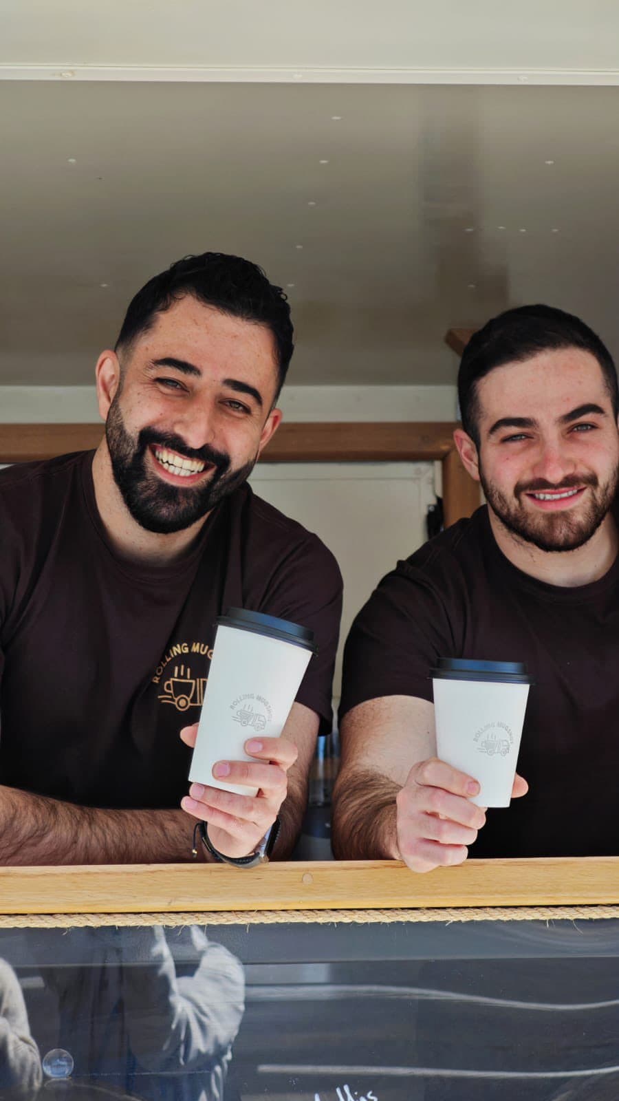 Brothers Jimmy and Ryan serving coffee from the Rolling Mugshot window